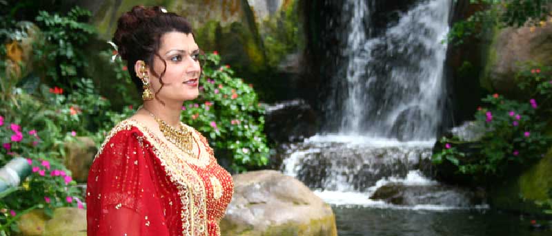 Beautiful bride awaiting her groom at a Maui waterfall wedding.